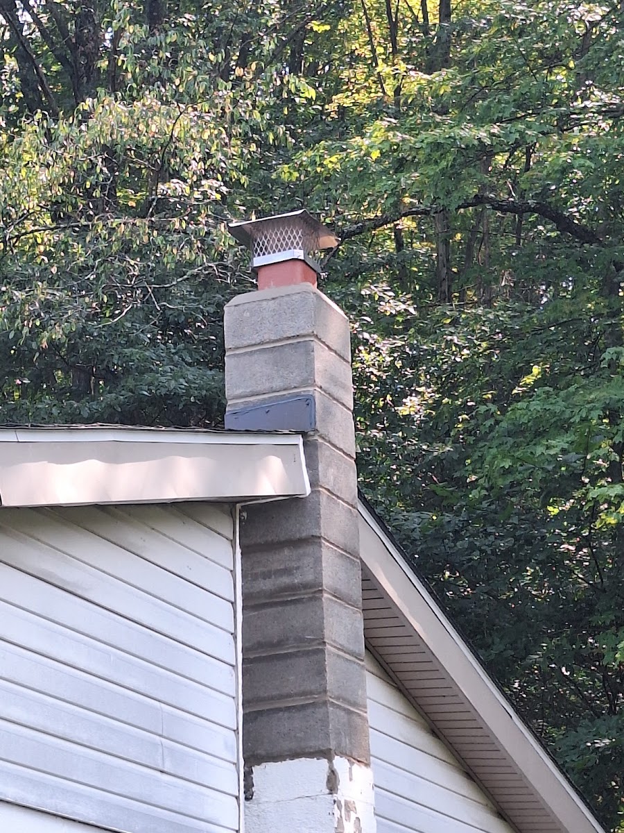 Rebuilt block chimney with new copper-toned chimney cap